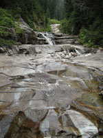Water cascades across rock slabs at Denny Creek.