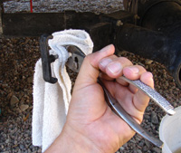 To remove the T handle, grasp the actuating rod with a pair of pliers while protecting the rod with a rag.