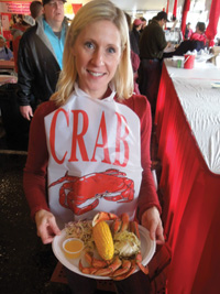 Crab dinner is served by a volunteer.