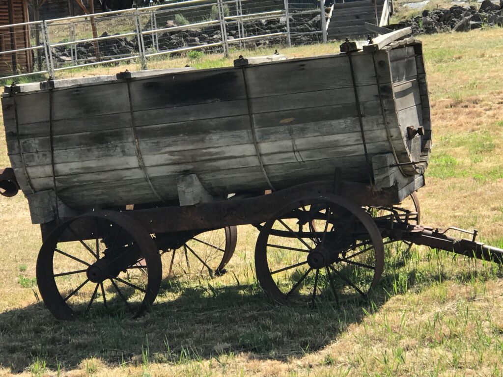 Along the Oregon Trail enroute to buy new a RV - antique wagon 