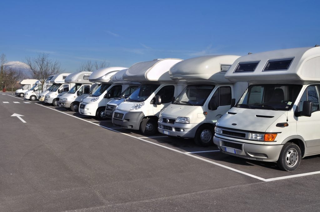 row of RVs on a dealership lot 