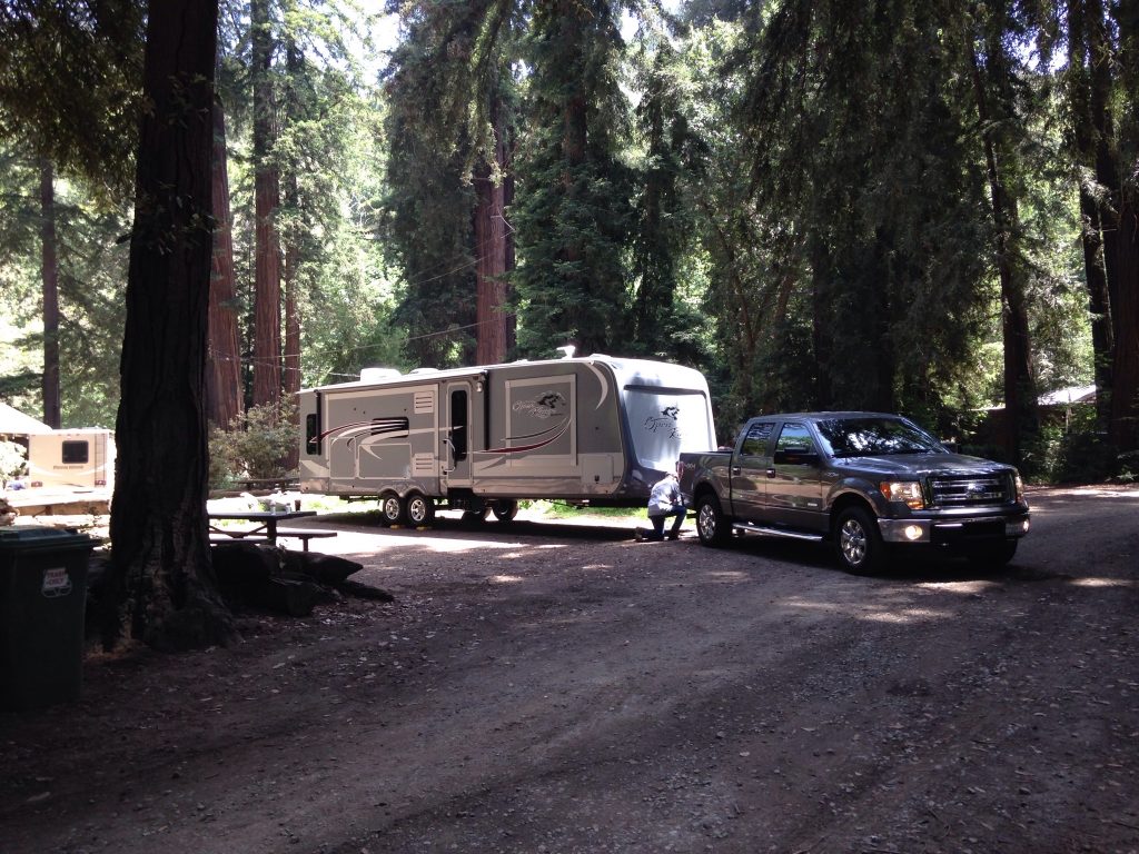 Truck backing up a travel trailer in one of the best RV parks