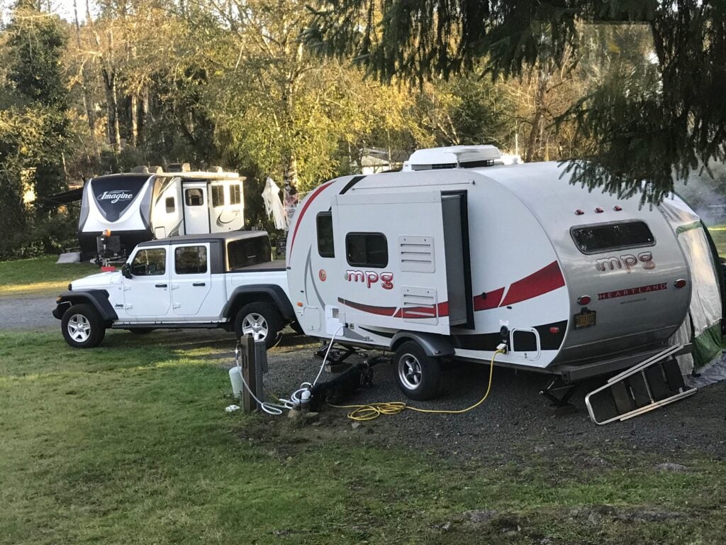 small camp trailer and jeep towing vehicle