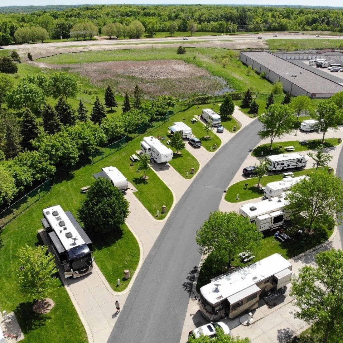 Aerial view of RV park with green grass