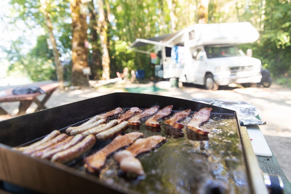 cooking a grill at an RV campsite