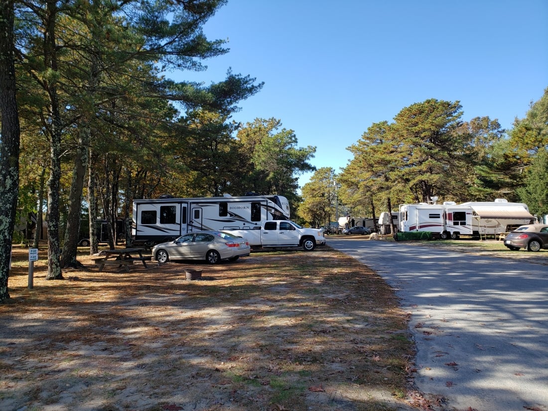paved road leading to sites with parked RVs