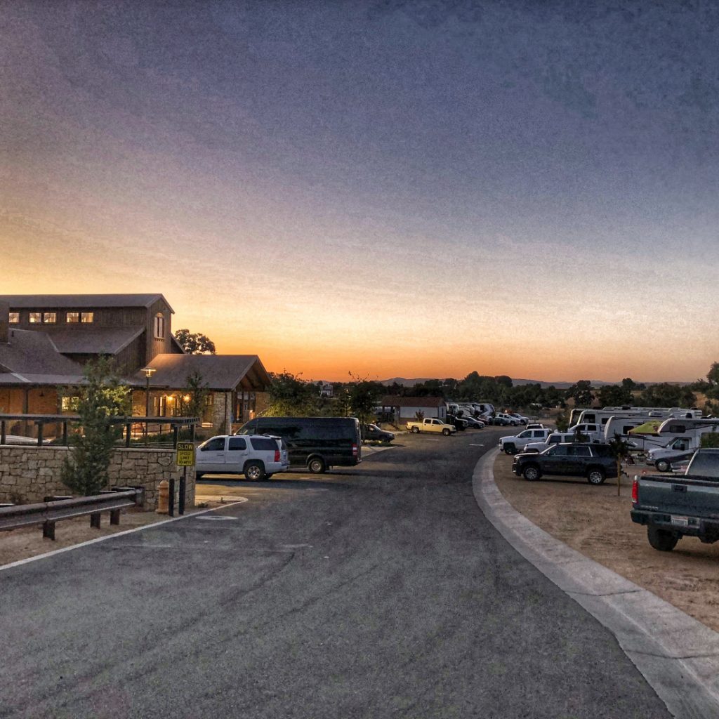 RV resort at dusk showing the clubhouse and road