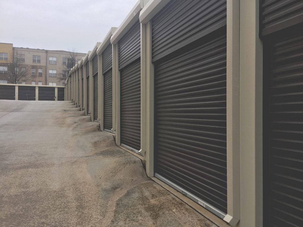 Row of storage units. When thinking about downsizing tips, you'll have to consider if a storage unit is right for you.