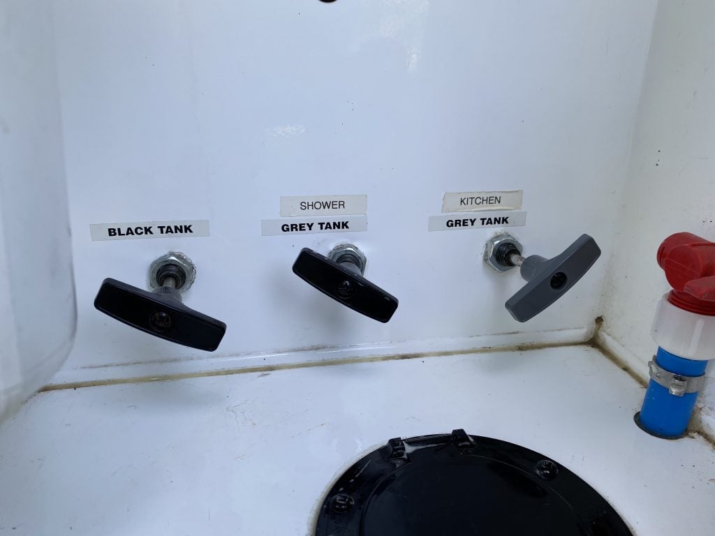 Three valves in an RV that are labeled black tank, shower grey tank, and kitchen grey tank. You'll want to use these when at an RV dump station. 
