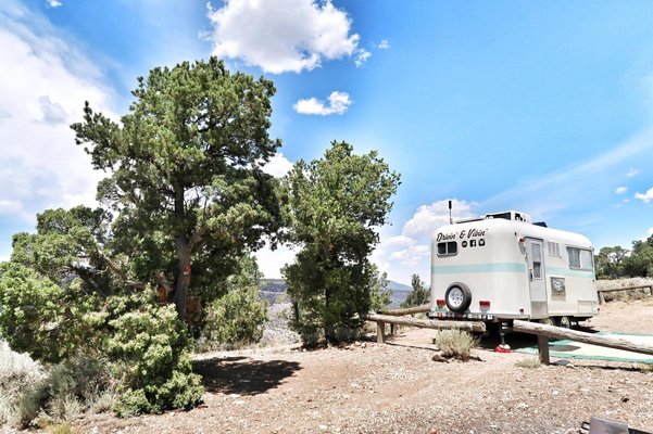 boondocking in new Mexico at the Cebolla Mesa Campground with trees and a a small camper