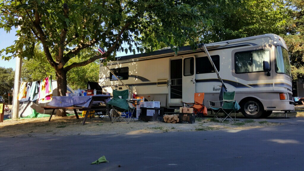 RV with chairs and tables out front. When it comes to how to set up a campsite, you'll want a great outdoor area
