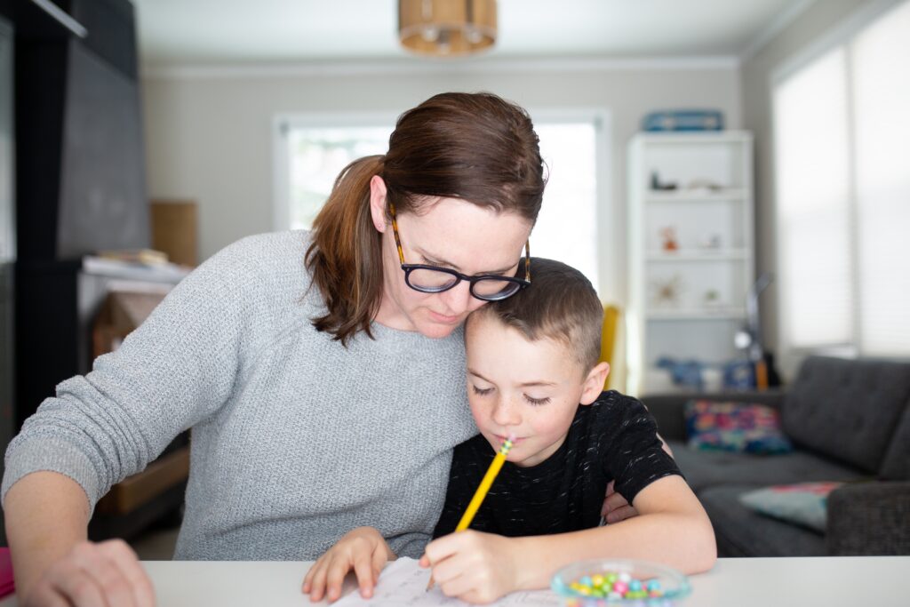 Mom and her son at home learning about the different styles of homeschooling