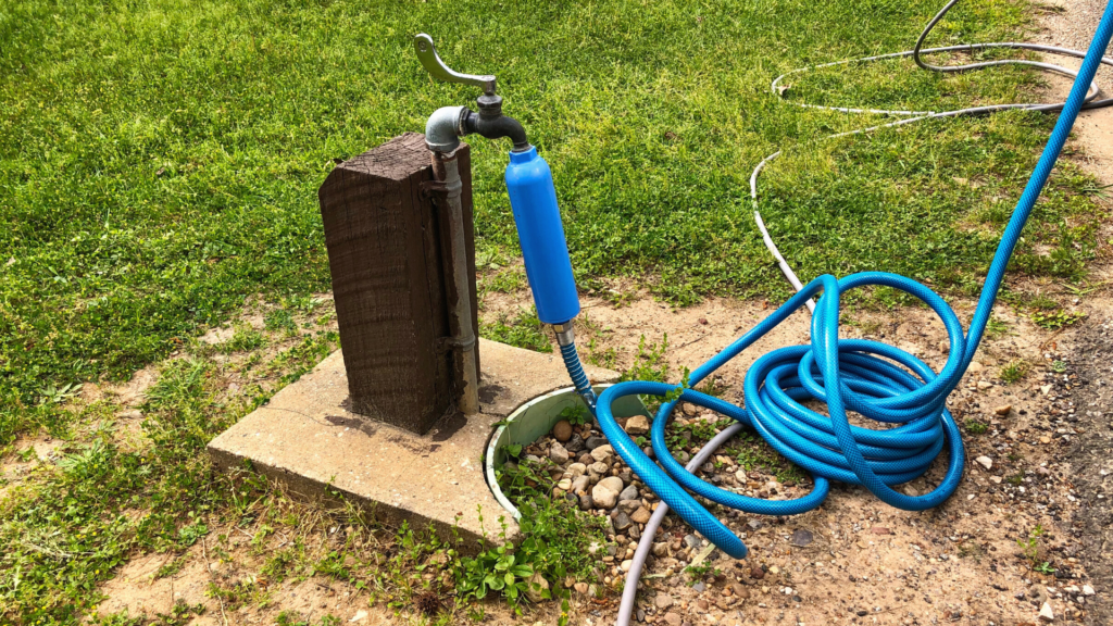 A campground spigot connected to a hose. This is a great option for RV fresh water fill stations.
