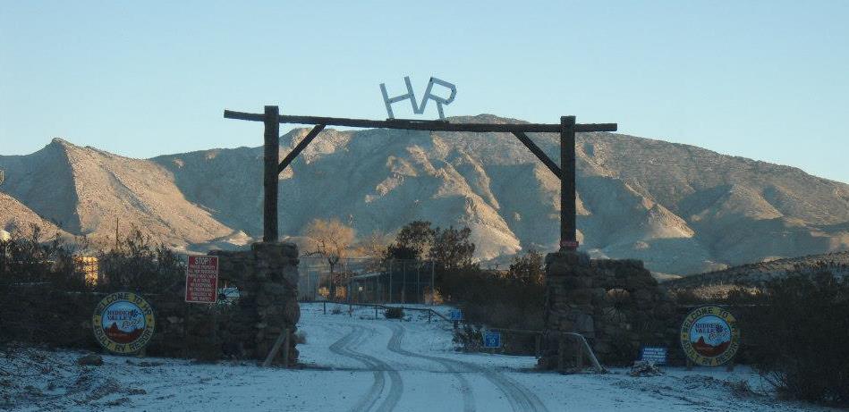 a light dusting of snow covers the entrance gate of Hidden Valley Ranch Resort