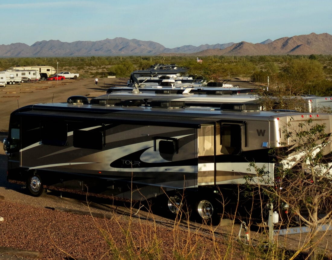 Class A RV in the foreground with mountains on the horizon