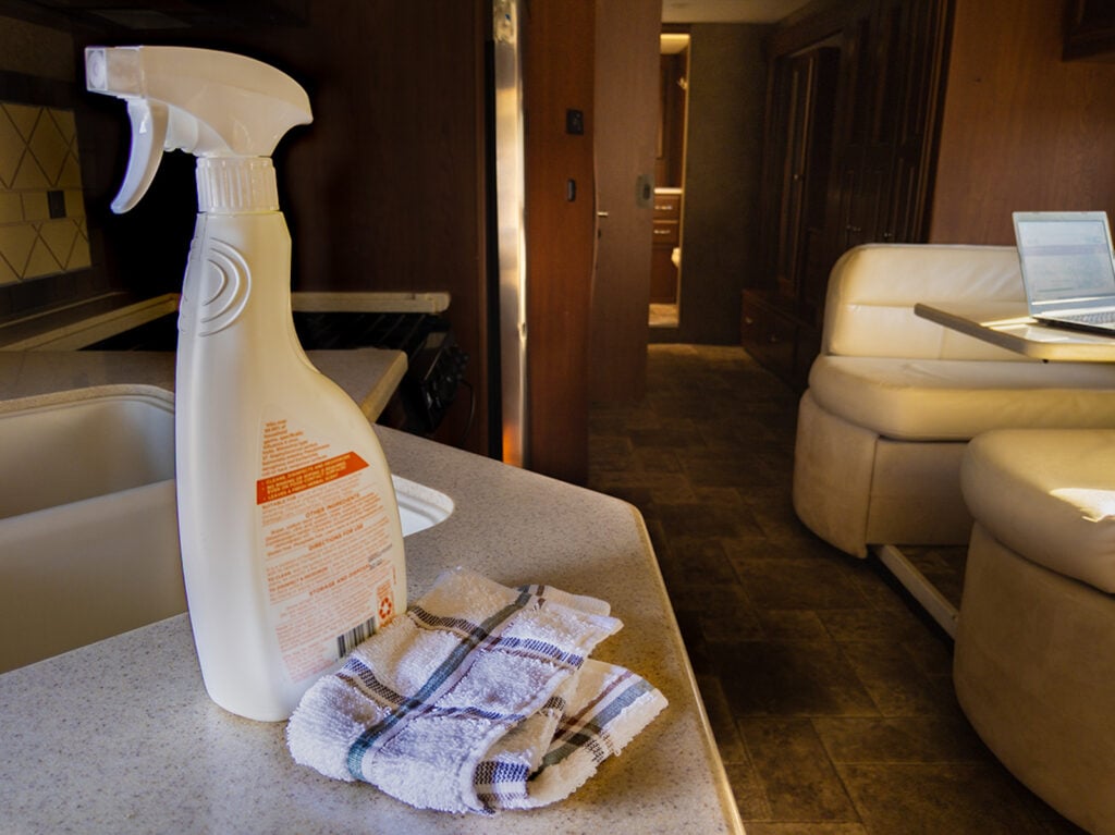 Spray bottle and rag used to clean RV interior. cleaning products, cleaning tips, motorhome, RV cleaning inside, interior detailing, sanitize, wiping down - Cleaning RV interior is part of the RV winterizing checklist