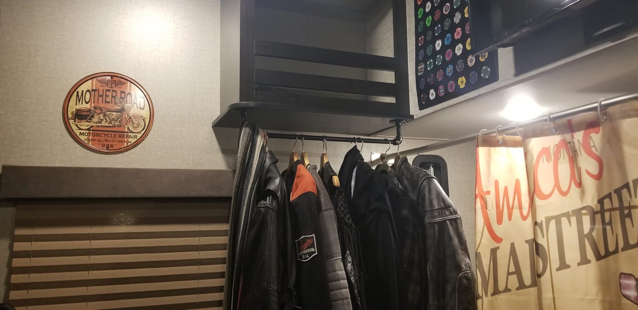 Coat hanger rack with jackets, vests, in garage
