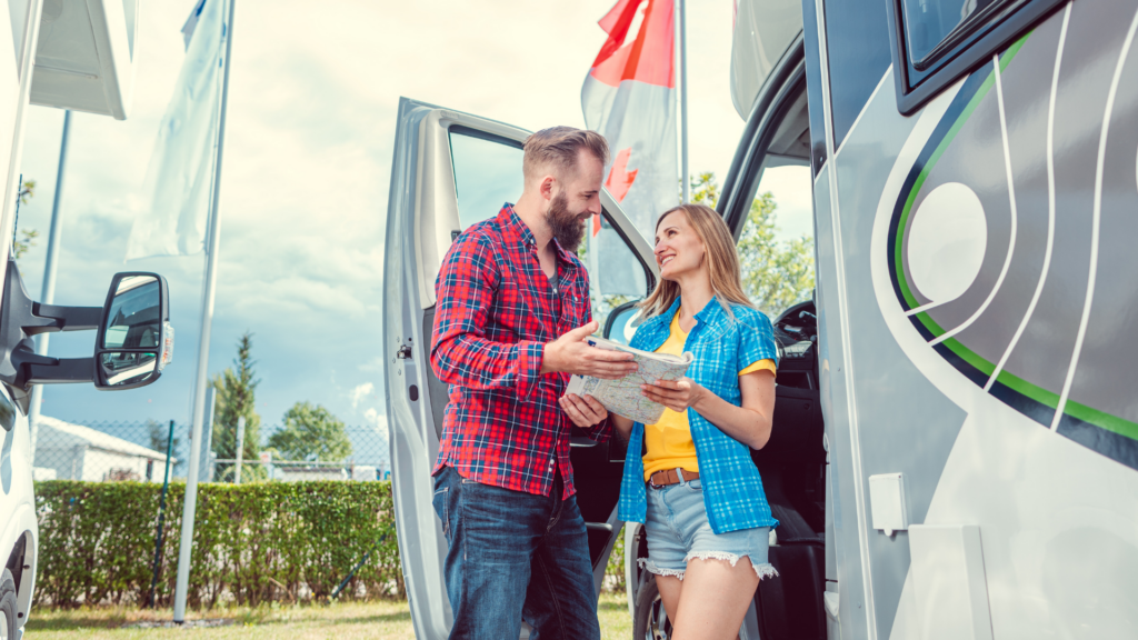 A woman at a dealership buying an RV out of state with a male salesman