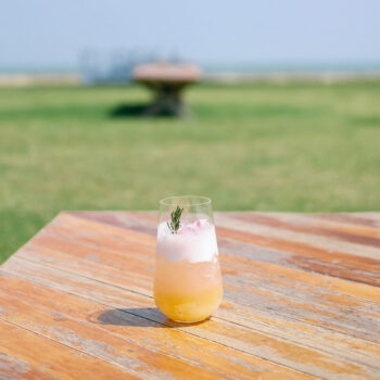 easy mixed drinks for camping - drink on wood table with grass background