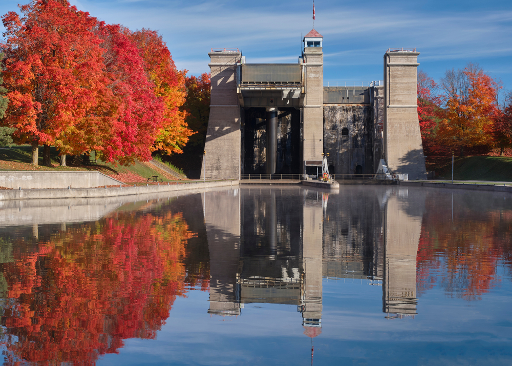 The Peterborough Lift Lock and surrounding colorful autumn trees are reflected in the Trent Canal.