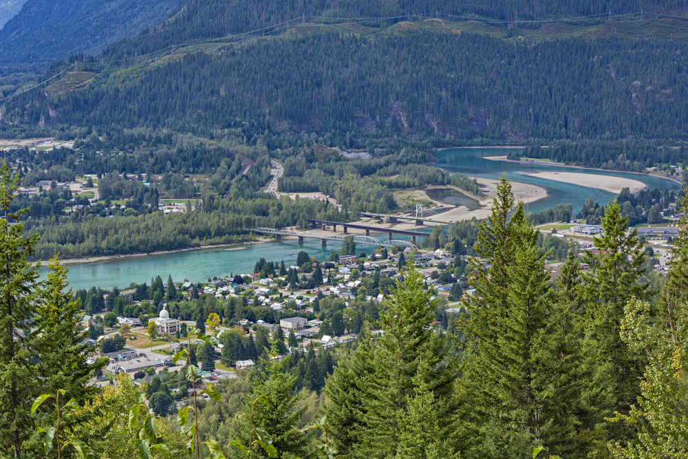 A view of Revelstoke townsite and bridges crossing the Columbia River. Visit Revelstoke while camping in British Columbia