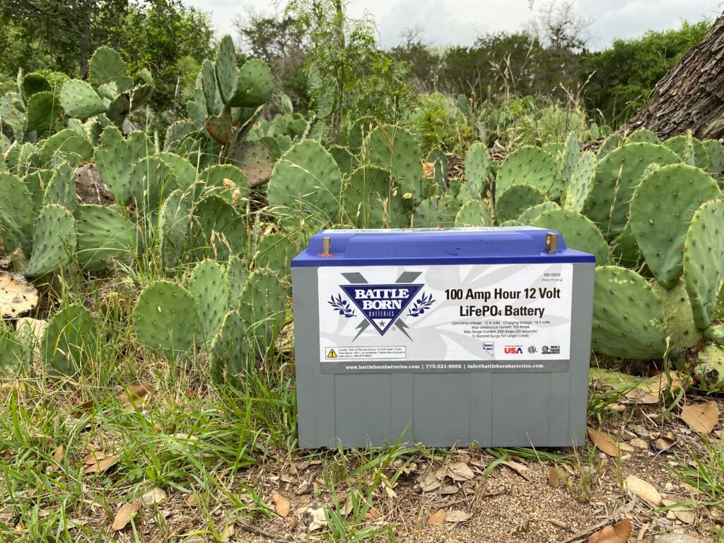 A Battle Born Battery sitting among cactus. This is the best rv battery for boondocking.