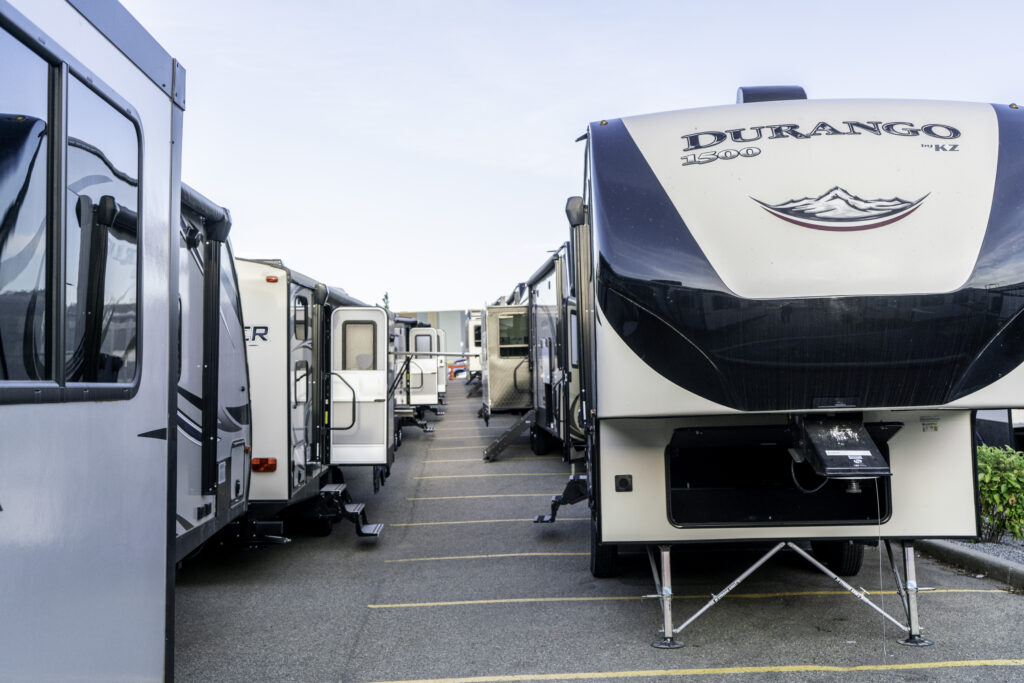 A row of RV with open doors ready for presentation at an RV show. 