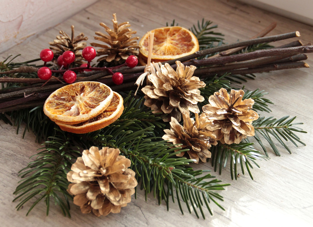 greenery with pinecones, dried orange slices and berries