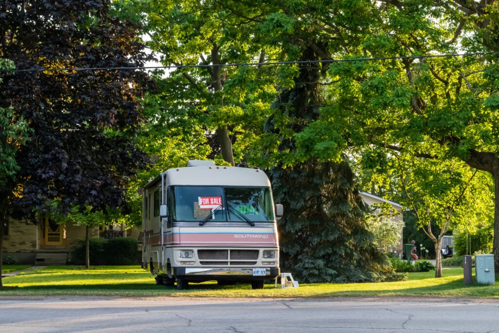RV for sale in yard - cover photo for Questions To Ask Before Buying An RV Out Of State