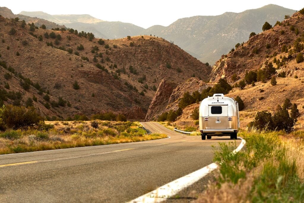 Airstream on road - feature image for How Much Propane Does An RV Fridge Use