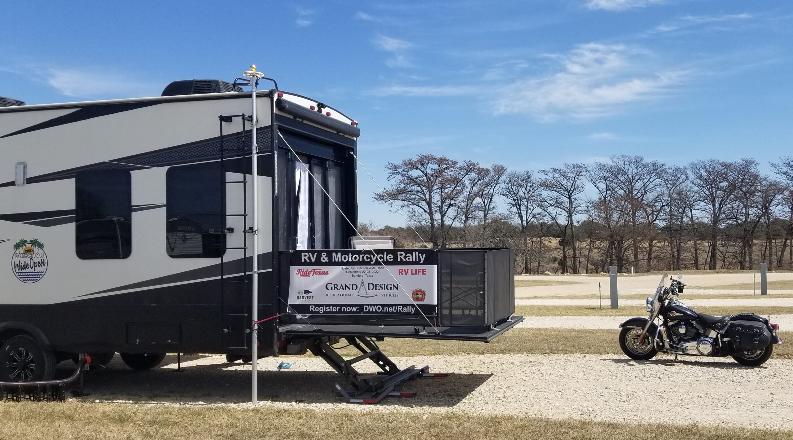 Back of Toy Hauler RV with Rally sign and motorcycle