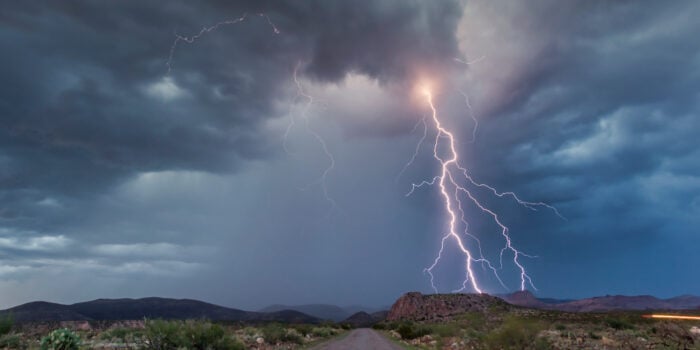 lightning over road in Arizona - feature image for Is An RV Safe In A Lightning Storm