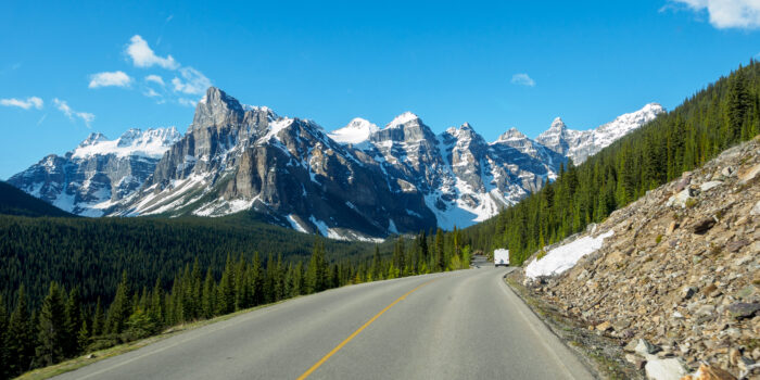 highway in Canada with mountains in distance - feature image for RV Camping in Canada