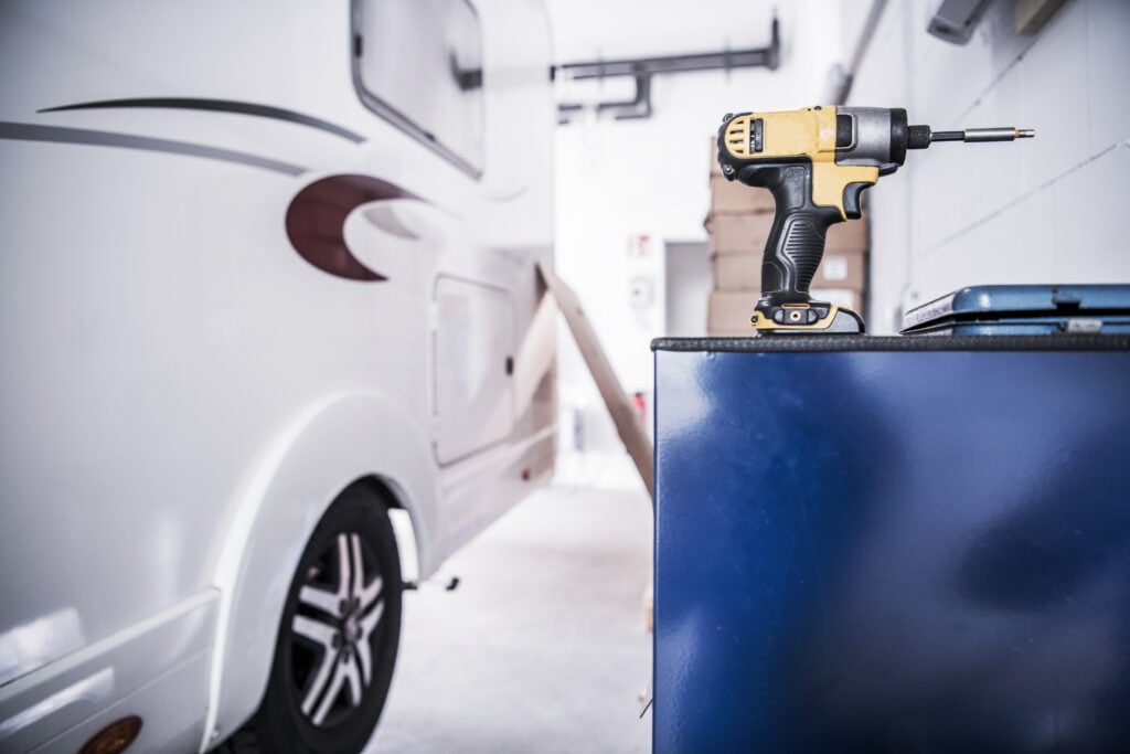drill next to motorhome - feature image for simple RV repairs