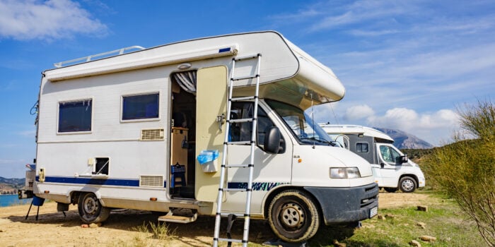 motorhome from the side at campsite - feature image for Can I Use Auto Wax On My RV?