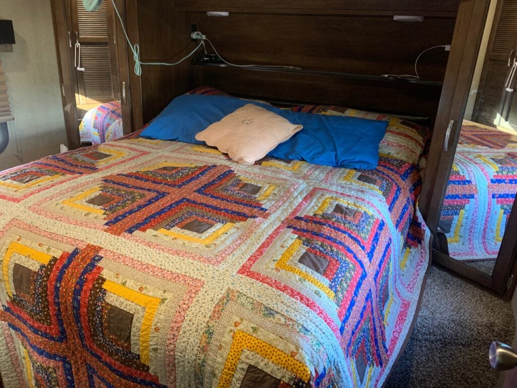 brightly color quilt with blue and pink pillow (Image: T. Nighswonger)