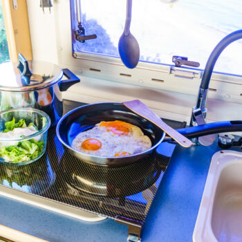 kitchen in an RV with food cooking - feature image for What To Cook In An RV