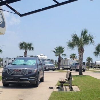 A Class C motorhome and SUV at a campsire at Stella Mare RV Resort.