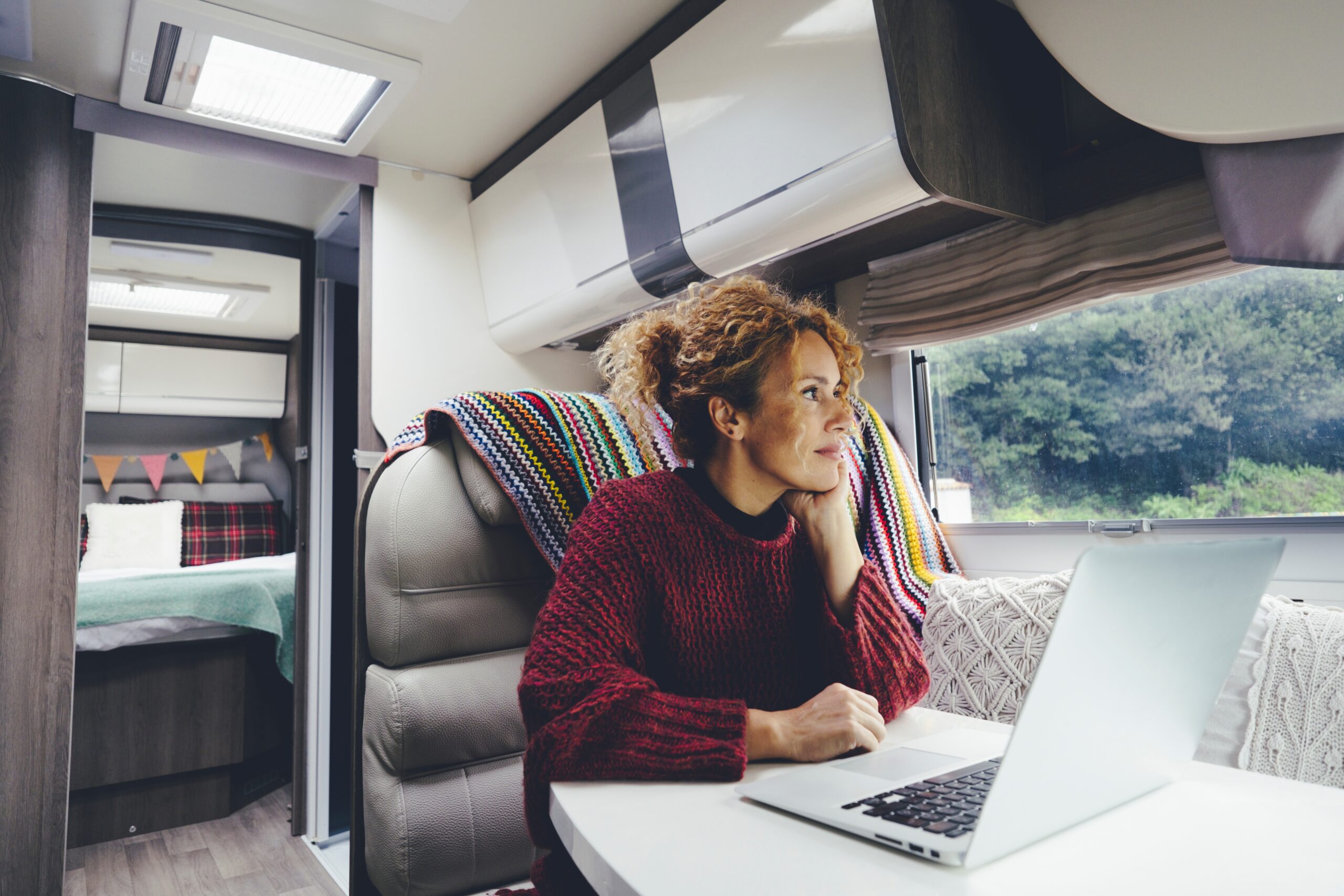 woman with laptop in RV - go RVing in retirement feature image