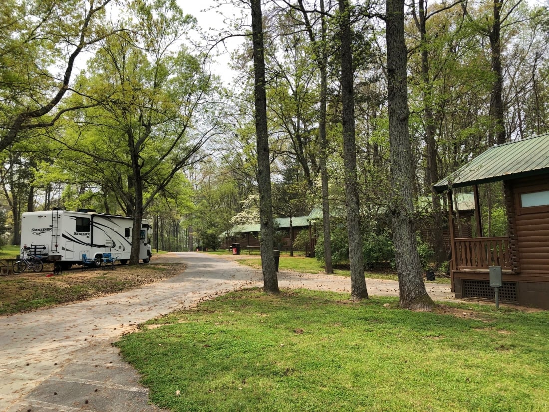 RV in campsite and cabin situated at Carowinds Camp Wilderness Resort