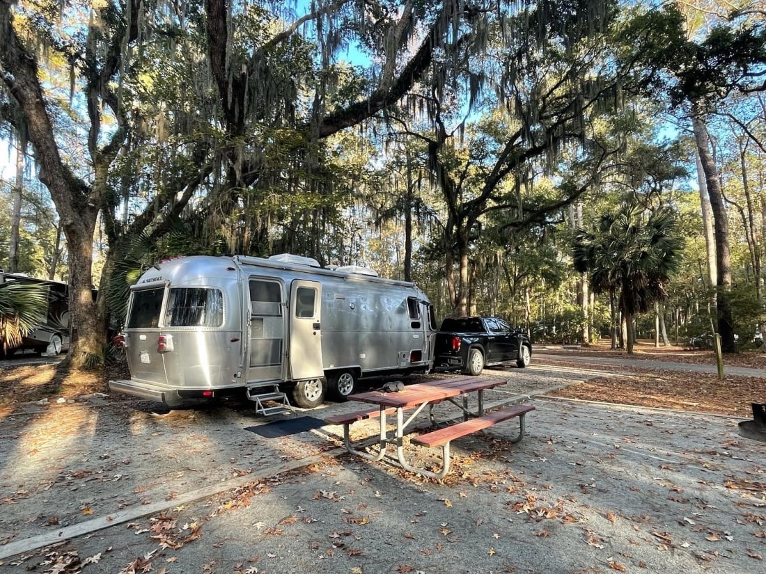 Airstream parked under shaded trees at Skidaway Island State Park campsite