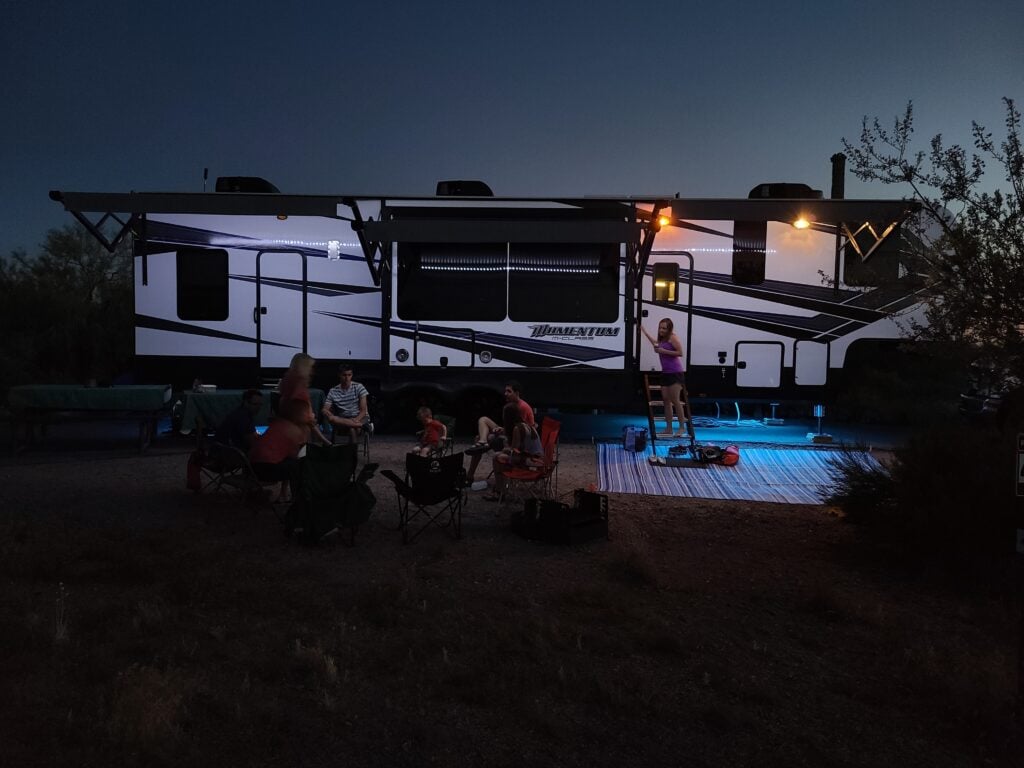 Family camping in a mobile home at night