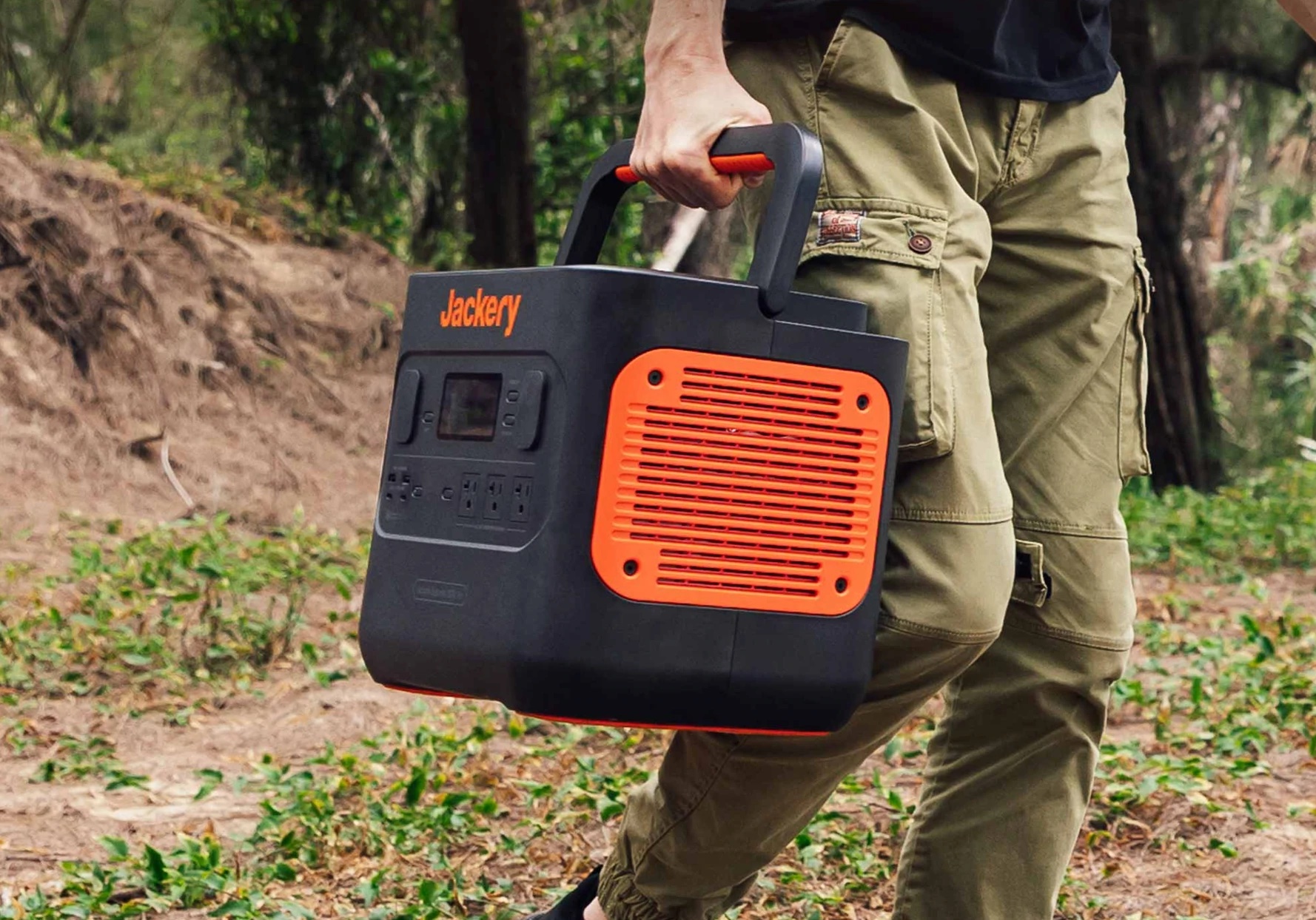 man carries Jackery portable power pack by the handle