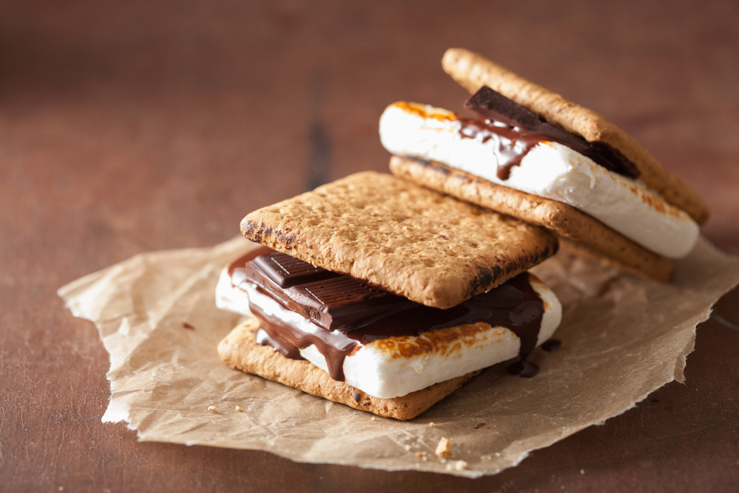 Totally vegan smores on parchment on wooden table