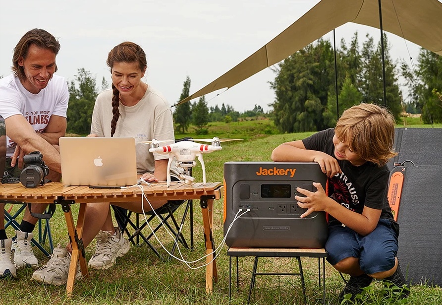 Content creators prepare a camera and drone for flight