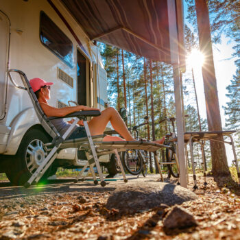 person sitting on chair in front of RV - feature image for best back exercises in the RV