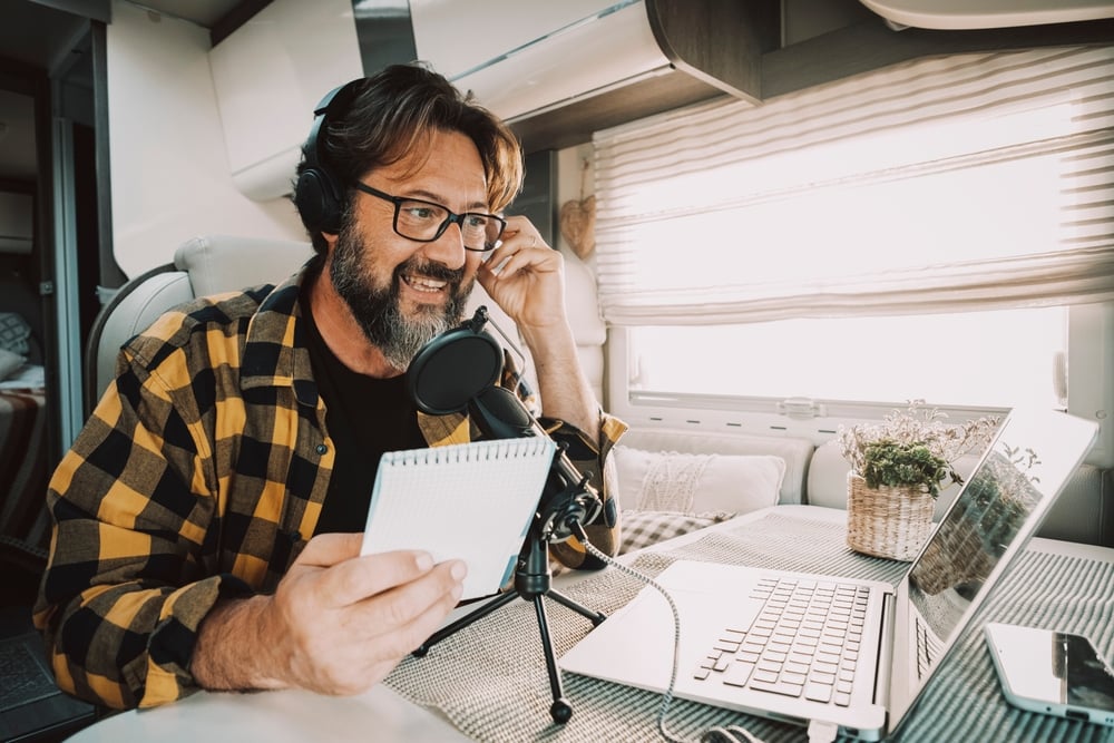 man in rv talking on microphone in rv audio podcast show