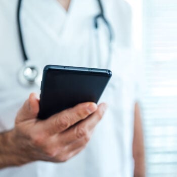 RV doctor holding phone - feature image for RV medical article
