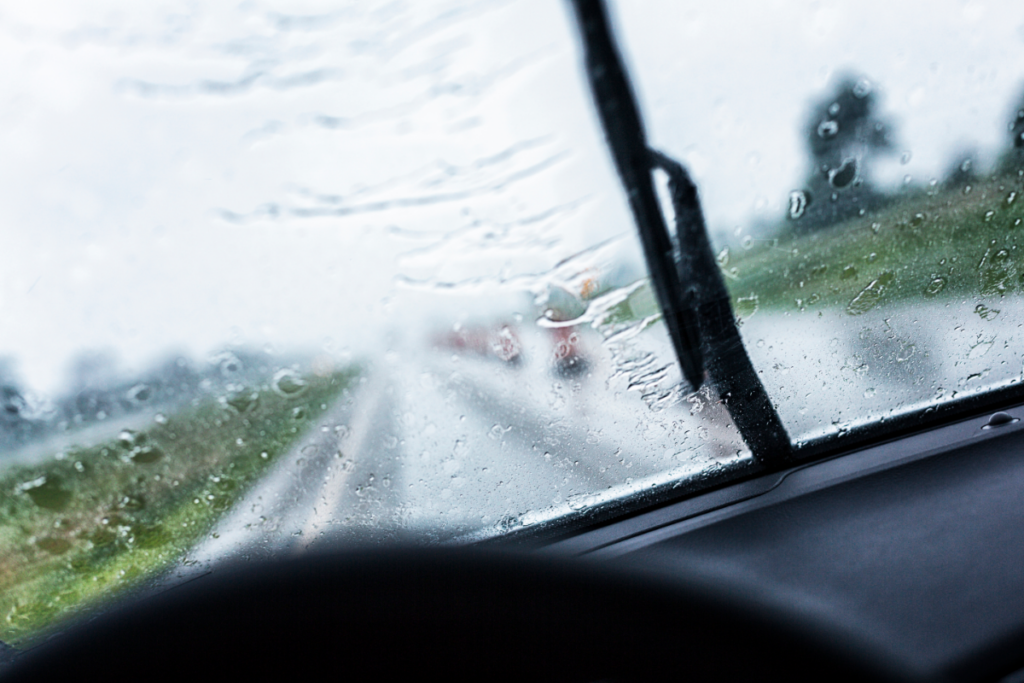 A rain covered windshield seen from inside