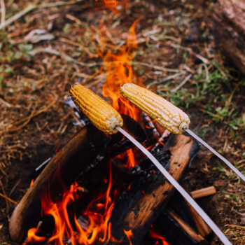 corn over fire, feature image for best way to cook corn on the cob